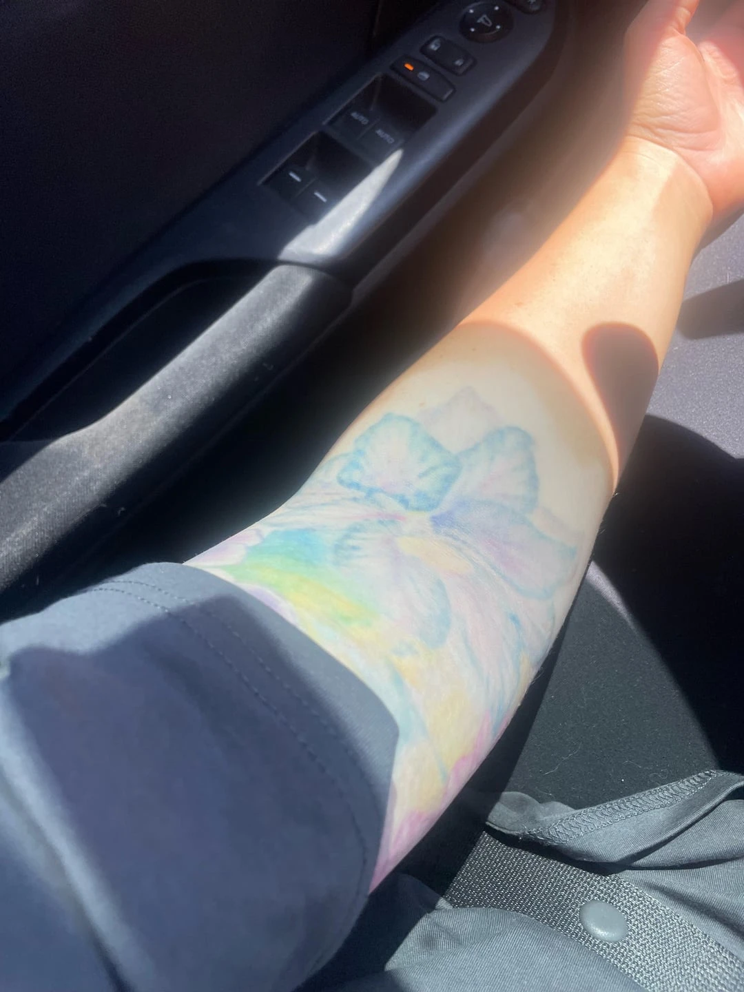 blue, purple, yellow and green tattoo before laser removal