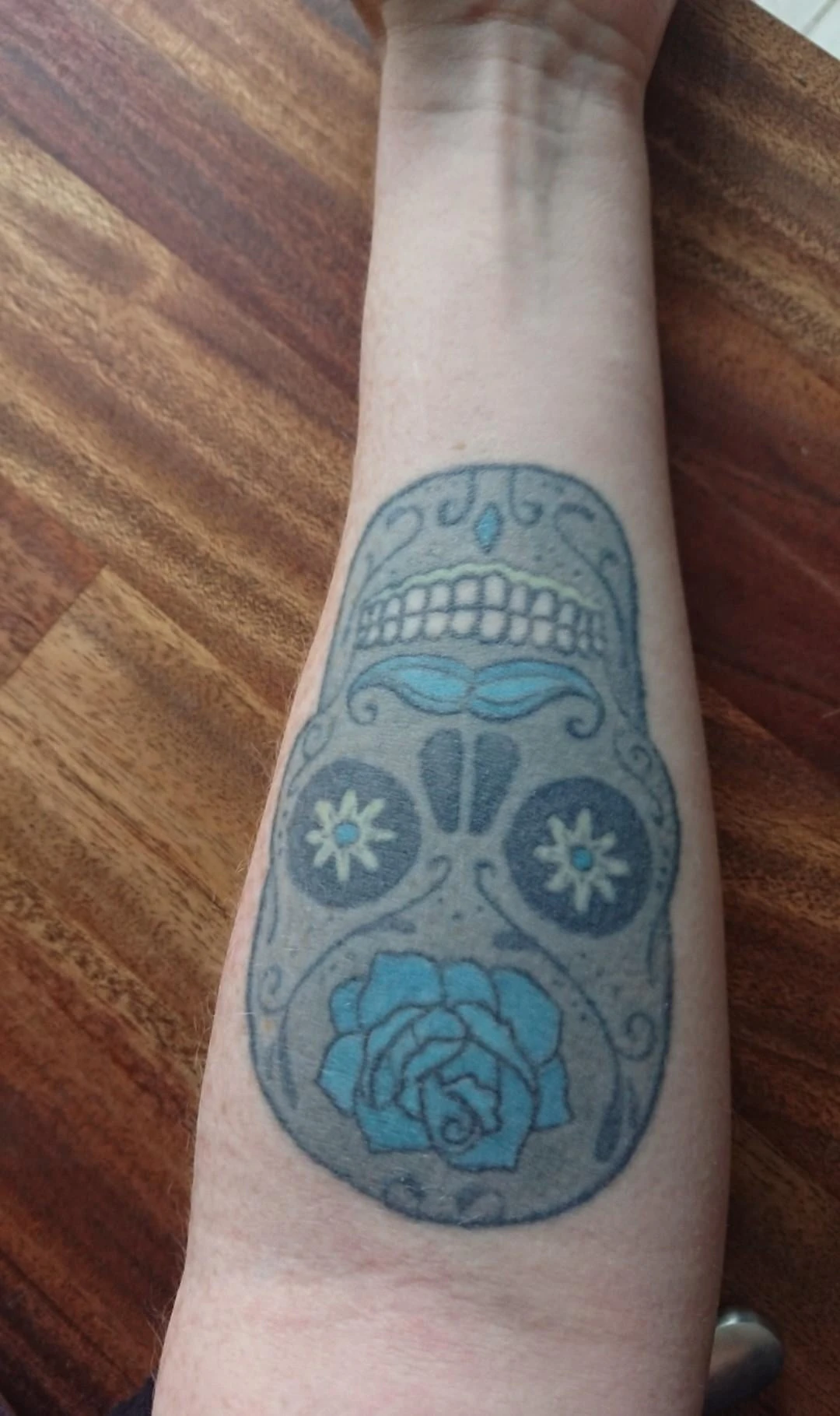 black, blue, green and yellow tattoo before laser removal